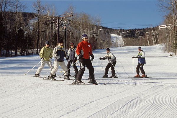 Skiiers and Snowboarders Ski  and Snowboard in Snow